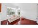 Bright sitting room with wood floors, chandelier, couch, and view to the outside at 940 Ashton Oaks Cir, Lakeland, FL 33813