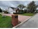 Beautifully landscaped single-Gathering home with a brick driveway and mailbox at 940 Ashton Oaks Cir, Lakeland, FL 33813