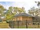 View of the house and screened-in porch from the fenced backyard at 1 Lake Eloise Ln, Winter Haven, FL 33884