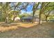 Spacious backyard featuring a screened-in pool, mature trees, and ample room for outdoor enjoyment and activities at 1 Lake Eloise Ln, Winter Haven, FL 33884