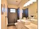Updated bathroom features a modern sink, black geometric tiling, and a walk in shower at 1 Lake Eloise Ln, Winter Haven, FL 33884