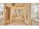 Bright bathroom featuring a garden tub beneath arched windows and a separate shower at 1 Lake Eloise Ln, Winter Haven, FL 33884