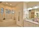Spacious bathroom with a garden tub, vanity with -and- sinks, and a large mirror at 1 Lake Eloise Ln, Winter Haven, FL 33884
