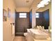 Updated bathroom features a modern sink, black geometric tiling, and a walk in shower at 1 Lake Eloise Ln, Winter Haven, FL 33884