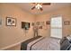 Bedroom featuring a ceiling fan, many decorations, and a large window at 1 Lake Eloise Ln, Winter Haven, FL 33884