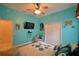 Bright, stylish bedroom with fun accents, closet, ceiling fan and TV at 1 Lake Eloise Ln, Winter Haven, FL 33884