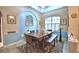 Stylish dining room with modern chandelier, large table, and decorative accents at 1 Lake Eloise Ln, Winter Haven, FL 33884