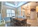 Bright dining area with tray ceilings, windows with shutters, and tile floors at 1 Lake Eloise Ln, Winter Haven, FL 33884