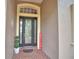 Elegant front entrance with decorative glass door, brick landing, and potted plants at 1 Lake Eloise Ln, Winter Haven, FL 33884