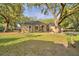 Charming single-story home with lush landscaping, mature trees, and a well-manicured lawn at 1 Lake Eloise Ln, Winter Haven, FL 33884