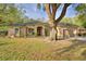 Charming single-story home with a well-manicured lawn and mature trees, providing shade and curb appeal at 1 Lake Eloise Ln, Winter Haven, FL 33884