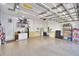 Spacious garage with epoxy flooring, storage shelves, and a convenient utility sink at 1 Lake Eloise Ln, Winter Haven, FL 33884