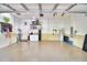 Well-lit garage with epoxy flooring, storage shelves, and a convenient utility sink at 1 Lake Eloise Ln, Winter Haven, FL 33884