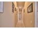 Well-lit hallway featuring tile flooring and tastefully decorated walls at 1 Lake Eloise Ln, Winter Haven, FL 33884