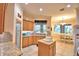 Charming kitchen with wood cabinets, granite countertops, a pantry, and an island at 1 Lake Eloise Ln, Winter Haven, FL 33884