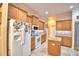 Cozy kitchen with wood cabinets, granite countertops, stainless-steel appliances, and a pantry at 1 Lake Eloise Ln, Winter Haven, FL 33884