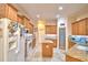 Well-lit kitchen with wood cabinets, granite countertops, and stainless-steel appliances at 1 Lake Eloise Ln, Winter Haven, FL 33884