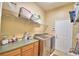 Functional laundry room with modern washer and dryer, storage shelf, and ample counter space at 1 Lake Eloise Ln, Winter Haven, FL 33884