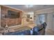 Spacious living room featuring brick accent wall with TV, and view of dining area at 1 Lake Eloise Ln, Winter Haven, FL 33884