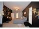 Main bedroom showcasing dark accent wall, ceiling fan, wood floors, and neutral colored bed spread at 1 Lake Eloise Ln, Winter Haven, FL 33884