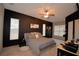 Main bedroom with wood-look floors, neutral bedding, many windows, and a ceiling fan at 1 Lake Eloise Ln, Winter Haven, FL 33884