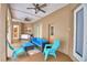 Covered patio featuring comfortable seating, ceiling fans, and ample space for relaxation and entertaining at 1 Lake Eloise Ln, Winter Haven, FL 33884