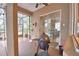 Covered outdoor patio featuring a grill and view of the screened in lanai at 1 Lake Eloise Ln, Winter Haven, FL 33884