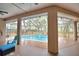 Screened in lanai boasts a beautiful pool with waterfall features surrounded by nature at 1 Lake Eloise Ln, Winter Haven, FL 33884