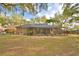 Backyard with a screened-in pool, perfect for enjoying a refreshing swim in a private setting at 1 Lake Eloise Ln, Winter Haven, FL 33884