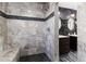 Bathroom shower featuring stone tile, modern fixtures, and integrated bench seating at 115 W Christina Blvd, Lakeland, FL 33813