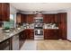 Well-equipped kitchen featuring stainless steel appliances, granite countertops, and modern tile backsplash at 115 W Christina Blvd, Lakeland, FL 33813