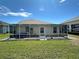 Screened lanai and green grass at 1155 Motorcoach Dr, Polk City, FL 33868