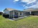 A view of the screened in lanai from the backyard at 1155 Motorcoach Dr, Polk City, FL 33868