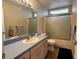 Cozy bathroom with shower, tub, vanity and wood look floors at 1155 Motorcoach Dr, Polk City, FL 33868
