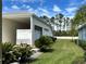 Property includes manicured landscaping and a covered carport perfect for additional parking at 1155 Motorcoach Dr, Polk City, FL 33868