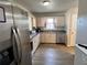 Well-lit kitchen features stainless steel appliances and wood cabinets with durable laminate floors at 1155 Motorcoach Dr, Polk City, FL 33868