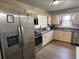 Bright kitchen featuring stainless steel appliances, and plentiful cabinet storage at 1155 Motorcoach Dr, Polk City, FL 33868