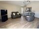 Cozy living room featuring modern flooring, neutral walls, and comfortable seating arrangement at 1155 Motorcoach Dr, Polk City, FL 33868