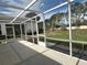 This is a view of the screened in lanai/patio with a concrete floor and a view of the backyard at 1155 Motorcoach Dr, Polk City, FL 33868