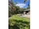 Backyard shows patio with stone table and seating beneath shade at 1197 De La Palma Ave, Bartow, FL 33830