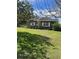 Single-story home has a well-maintained lawn, and mature trees at 1197 De La Palma Ave, Bartow, FL 33830