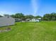 A backyard featuring green grass, mature trees and a fenced perimeter at 1310 Parker Rd, Lakeland, FL 33811