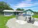 Backyard with above ground pool next to garage and screened in patio area at 1310 Parker Rd, Lakeland, FL 33811