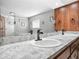 Bathroom with a double sink vanity with marble countertop and wood cabinets at 1310 Parker Rd, Lakeland, FL 33811