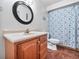 Bathroom with a vanity, toilet, and a shower with patterned curtains at 1310 Parker Rd, Lakeland, FL 33811