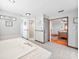 Large bathroom with a tub, a doorless shower, and entry to the bedroom at 1310 Parker Rd, Lakeland, FL 33811