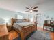 Spacious main bedroom featuring a wood bed frame, wood flooring and blue walls at 1310 Parker Rd, Lakeland, FL 33811