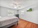 Bright main bedroom featuring a ceiling fan, wood floors and two windows with natural light at 1310 Parker Rd, Lakeland, FL 33811