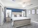 Spacious bedroom featuring neutral walls, a ceiling fan, and a beautifully decorated accent wall at 1746 Burrows Ave, Lakeland, FL 33811