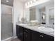 Double sink bathroom with shower and granite countertops at 1752 Burrows Ave, Lakeland, FL 33811